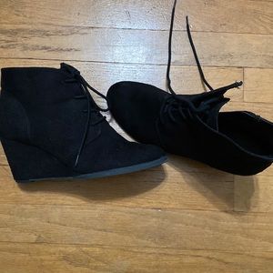 Black booties with wedge heel.